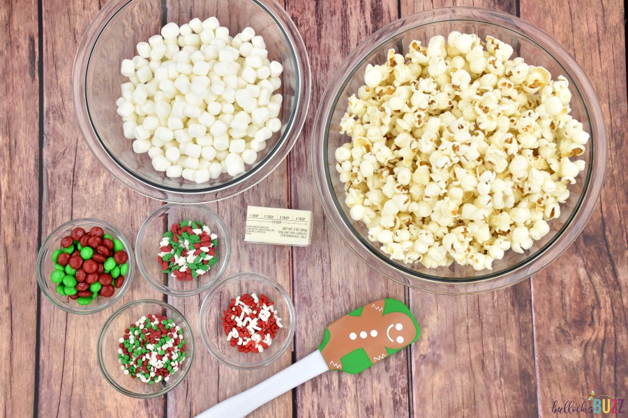 overhead image of Candy Claus Christmas Popcorn recipe ingredients separated into clear glass bowls