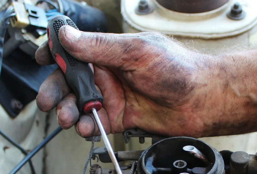 car mechanic working on reasons your check engine light is on