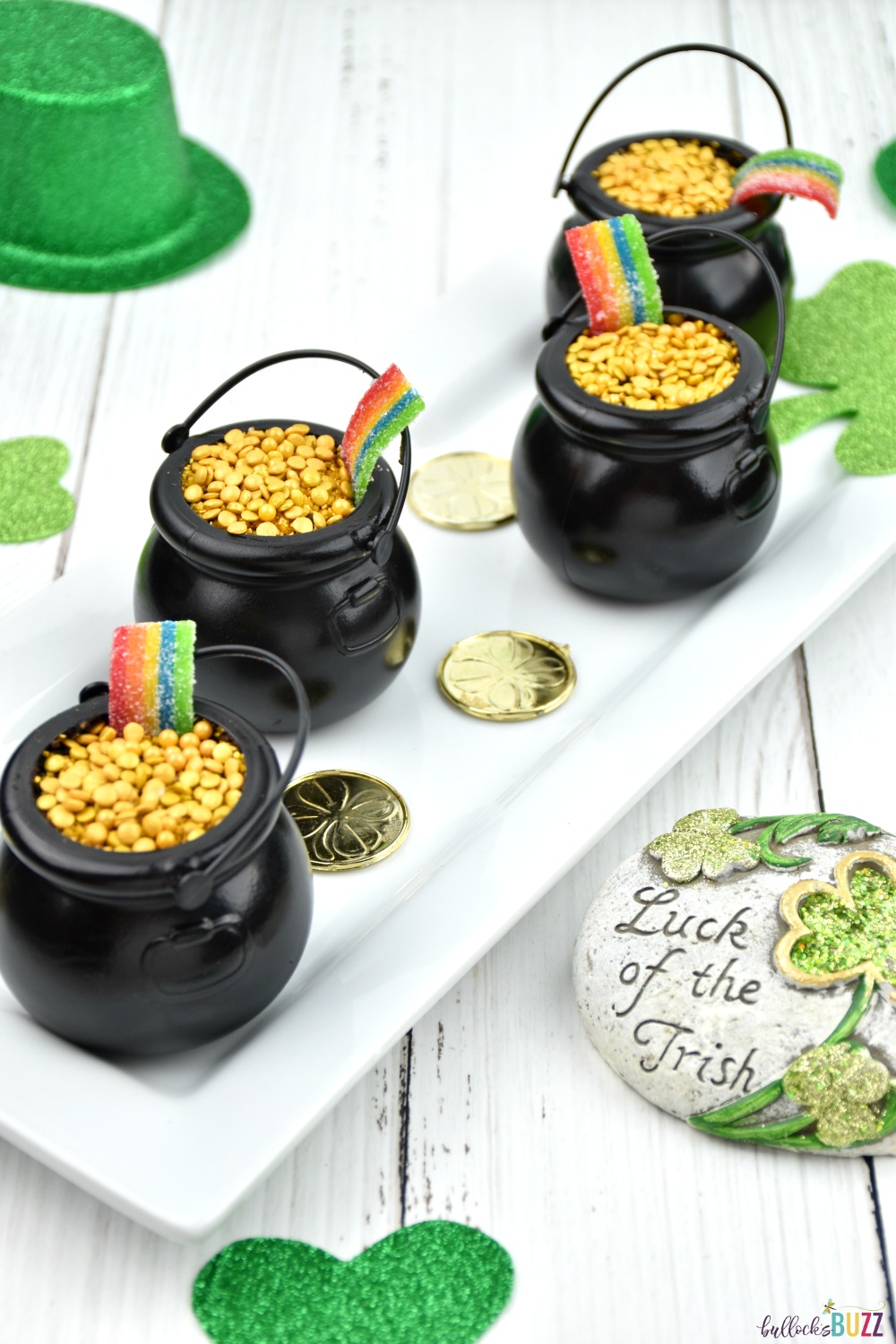 Grab your pudding mix, oreo crumbs, sprinkles, and rainbow candy and get ready to create the cutest St. Patrick's Day treats ever. with this Cup of Gold Dirt Cup recipe! #recipes #StPatricksDay #bullocksbuzz