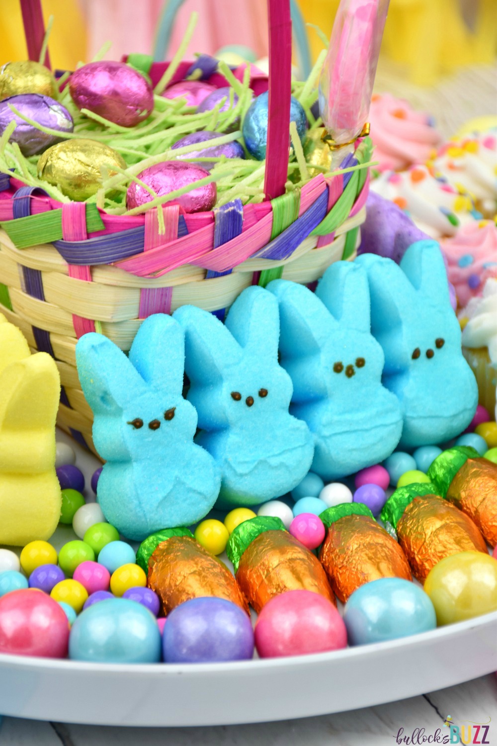 A closeup image of blue colored PEEPS bunny rabbits surrounded by colorful candies on the Easter Dessert Board