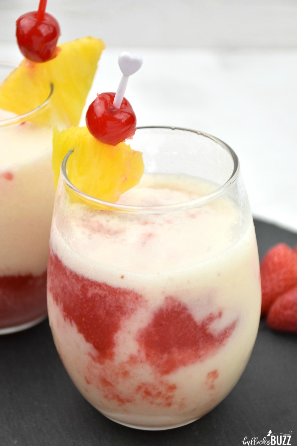 This slushy Lava Flow cocktail is absolutely delicious. The mixture of pineapple, strawberry, and coconut is a flavor combination made in heaven. Add some rum, and one sip will transport you to a tropical paradise! #cocktailrecipe #cocktail