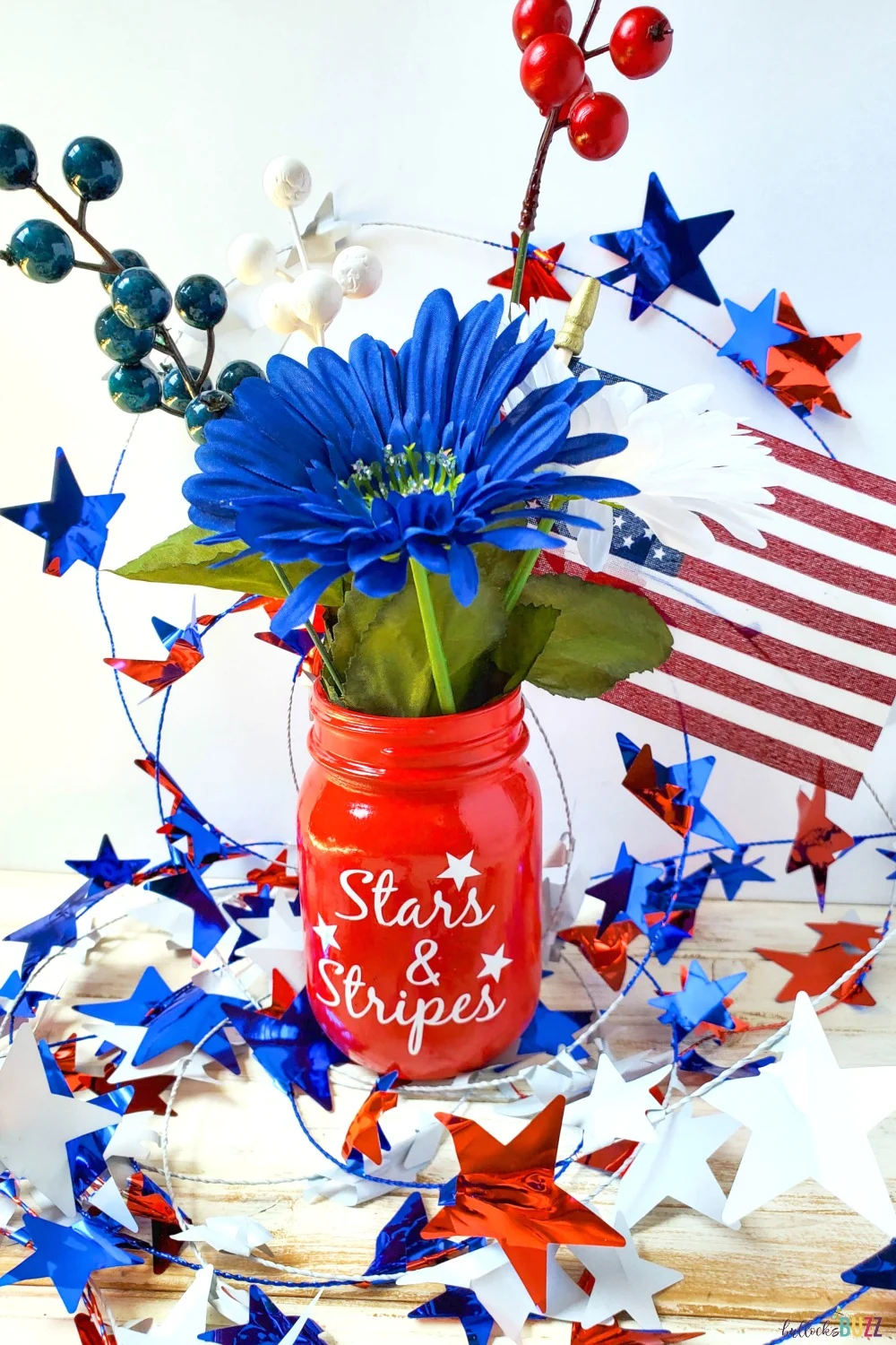 Your area will be transformed by this simple DIY Patriotic Mason Jar Centerpiece! This mason jar craft will add fun and festivity to your Fourth of July celebration! #crafts #patrioticcrafts