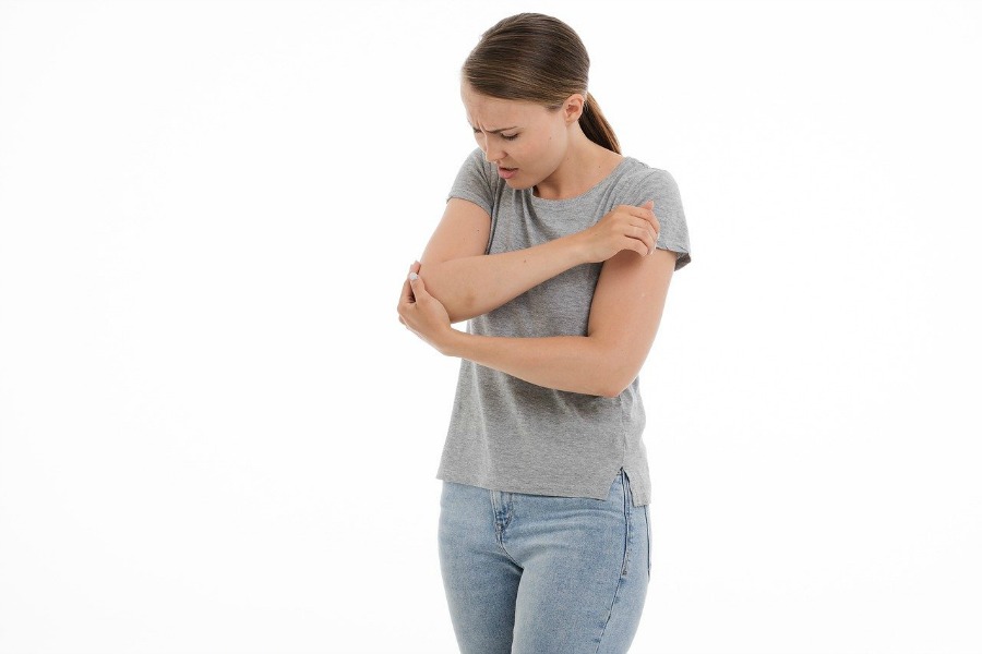 woman experiencing joint pain in her elbow