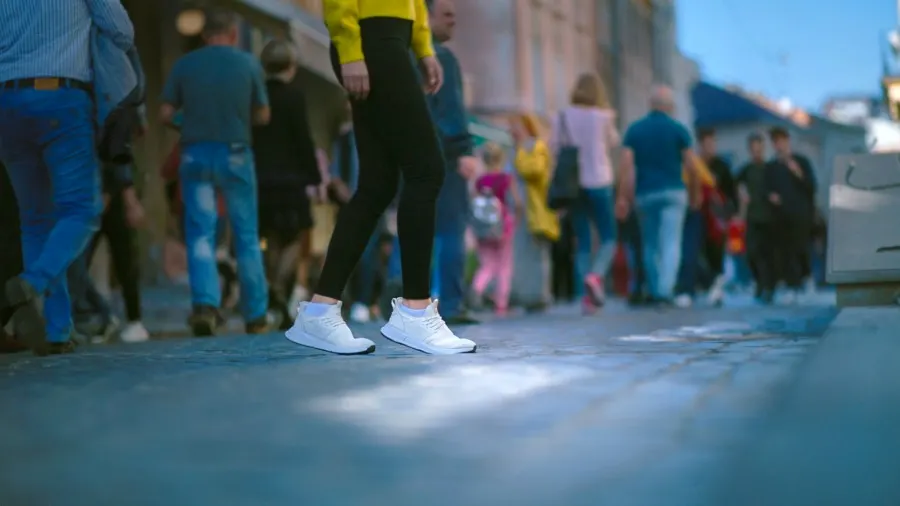 woman walking in loom sneakers