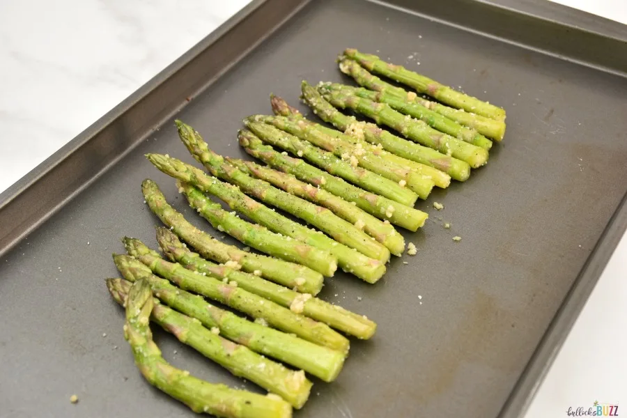 lay asparagus in a line on a baking sheet