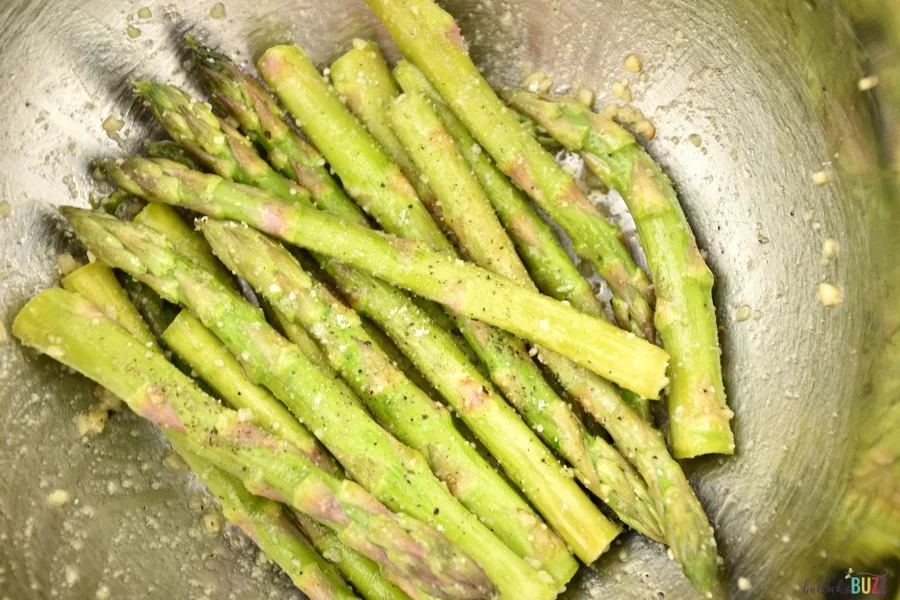 toss asparagus with olive oil and seasonings in a large bowl