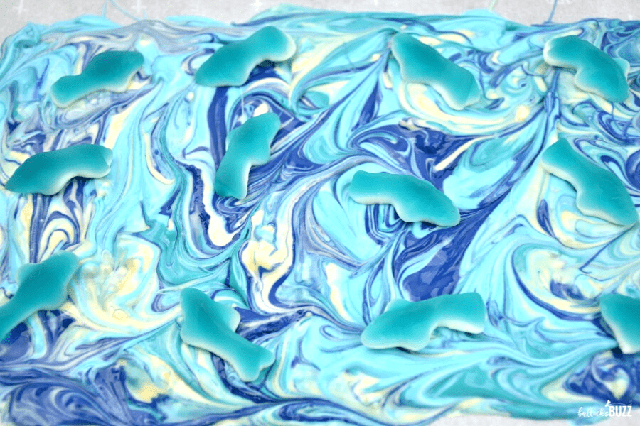 add gummy sharks to melted candy