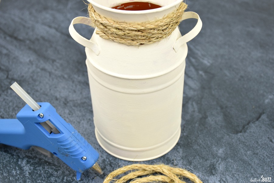 then hot glue the rope around the neck of the milk can