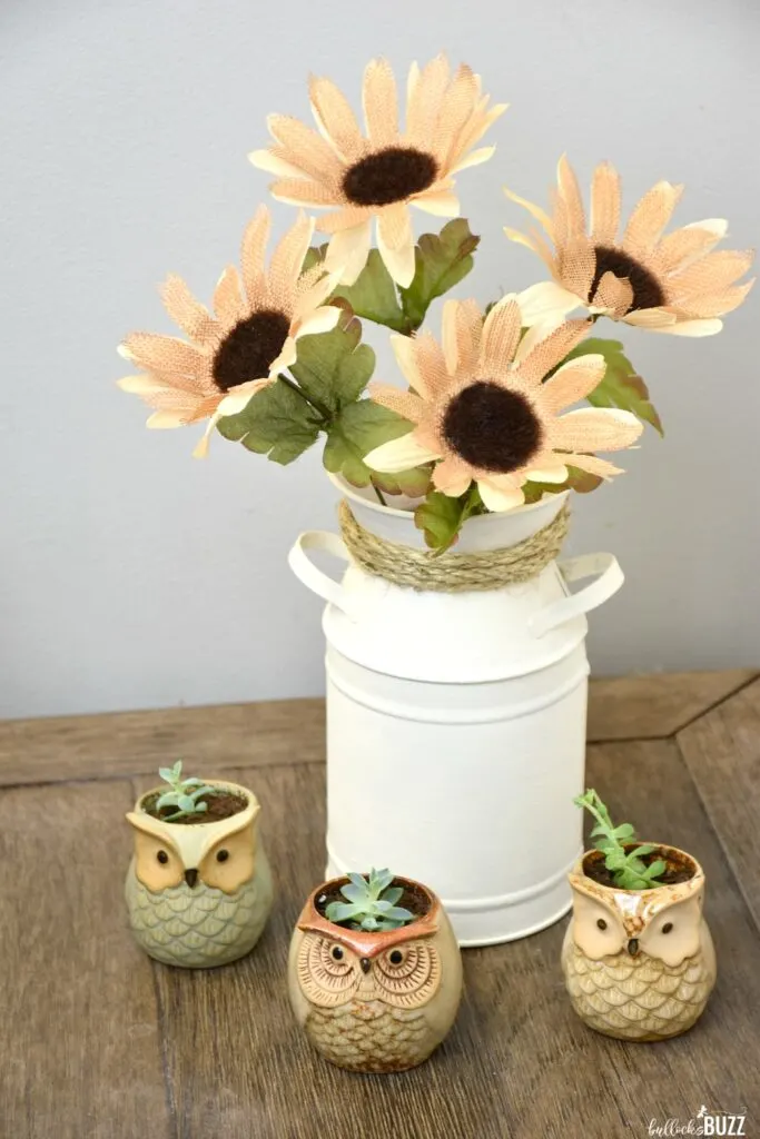 You can make this simple DIY Milk Can Vase Centerpiece in minutes using nothing more than a galvanized milk can, some paint, a bit of rope, and a few faux flowers.