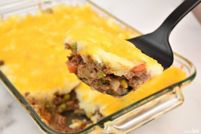 a slice of shepherd's pie with instant potatoes on a spatula recipe fresh out of oven