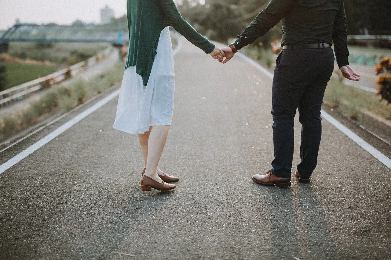 man and woman holding hands 