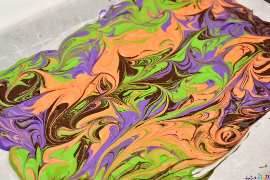 swirled Halloween candy bark on baking sheet