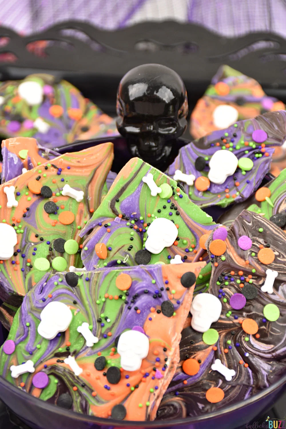 Swirled Halloween Candy Bark in bowl. This easy, no-bake Halloween Candy Bark is a scream! Get the recipe on the Bullock's Buzz blog.