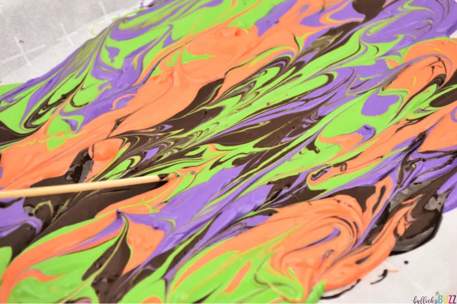 use a toothpick or skewrer to swirl melted candy colors together