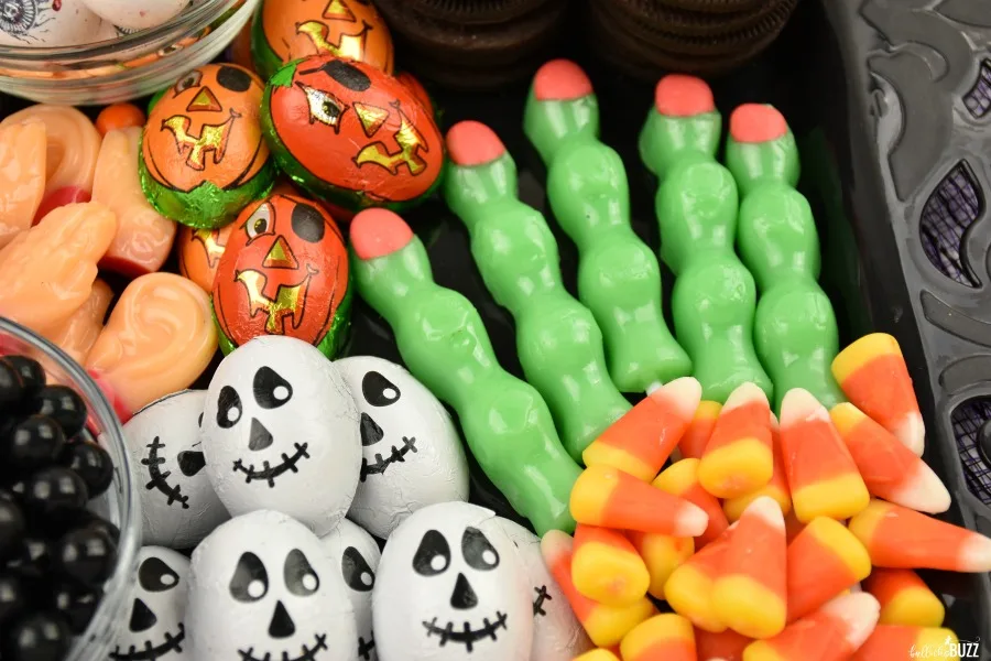 close up of zombie fingers, chocolates, and candy corn on the Halloween Candy Charcuterie Board