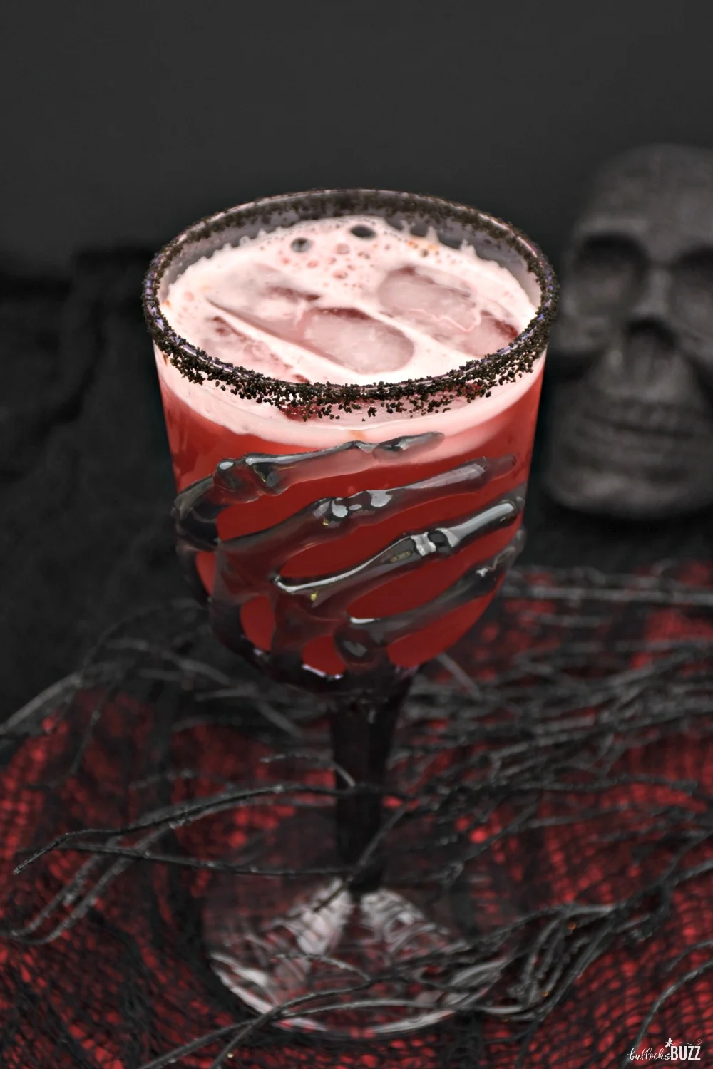 This Vampire's Kiss cocktail is hauntingly easy to make. It requires just a few simple ingredients including cranberry juice, spiced rum, pineapple juice, and a splash of grenadine.