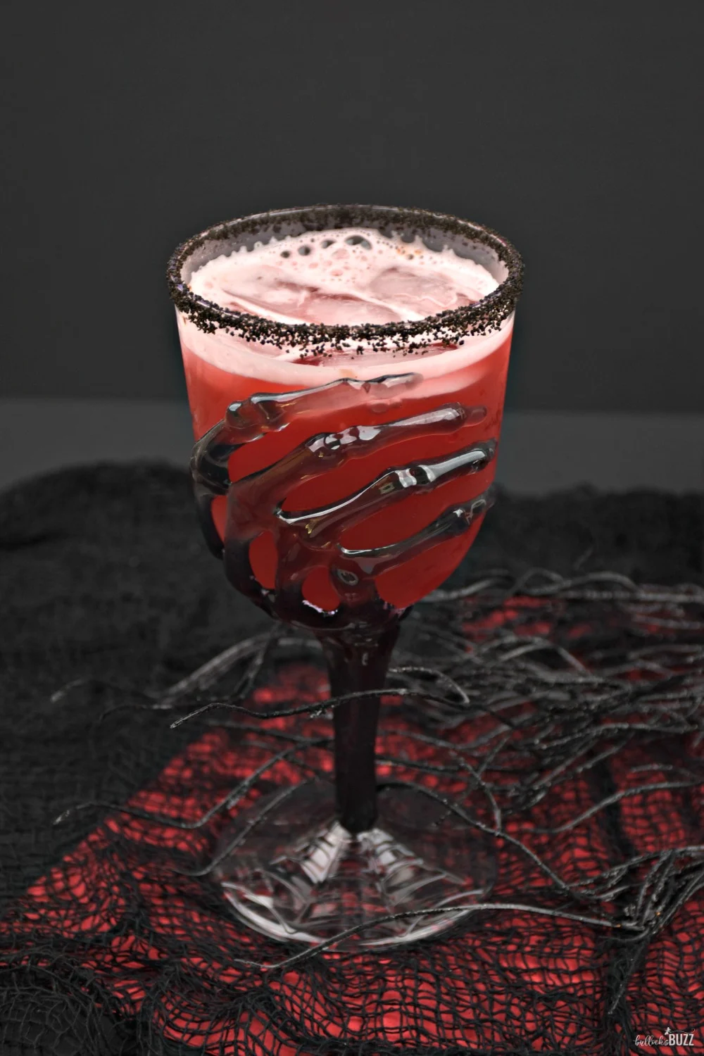 The Vampire's Kiss Halloween cocktail is sure to please both mortals and vampires alike with its fruity taste and spooktacular color!