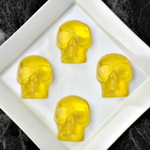 Halloween boozy gummy skulls on plate