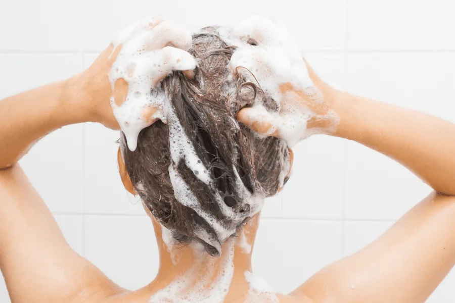 woman shampooing her hair