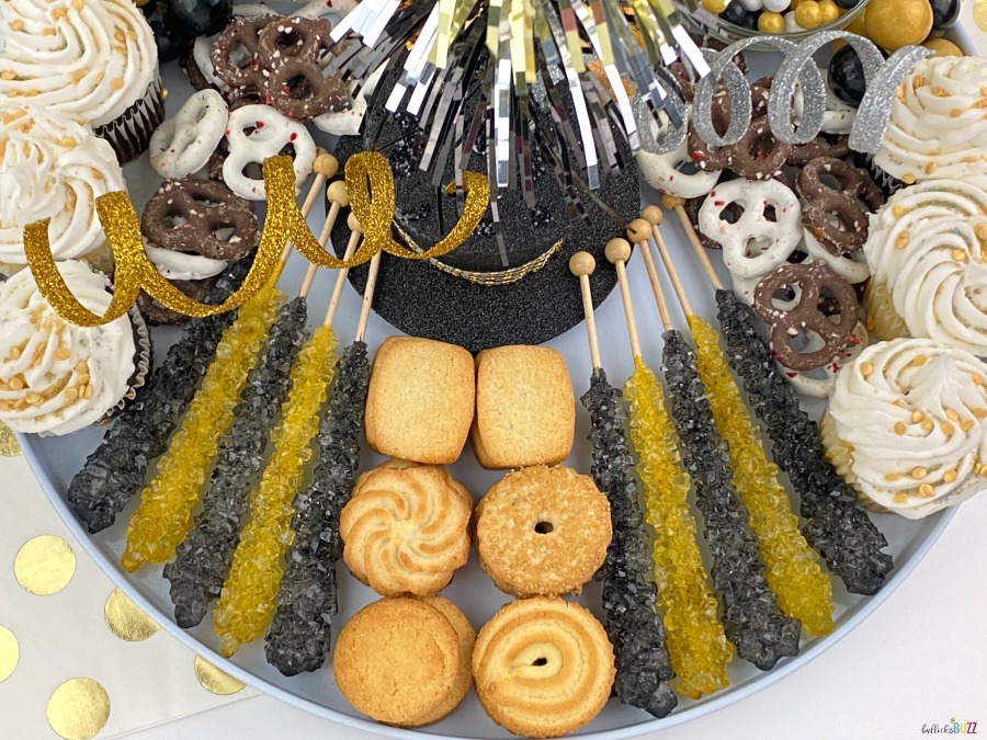 rock candy and cookies on dessert board for new Year's Eve