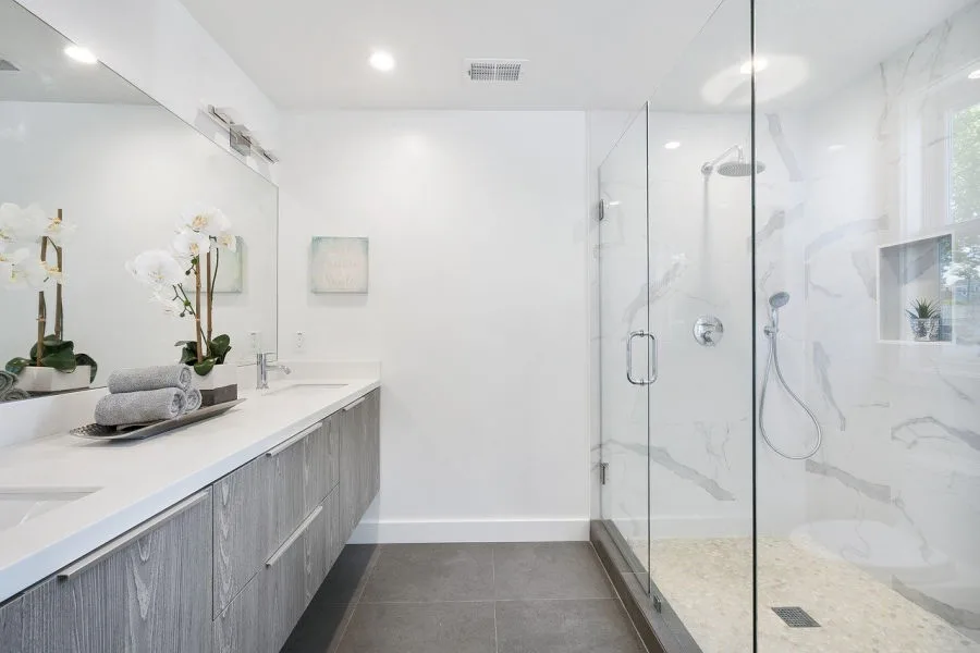 adding some flair such as the plant on this bathroom counter is an easy DIY bathroom idea