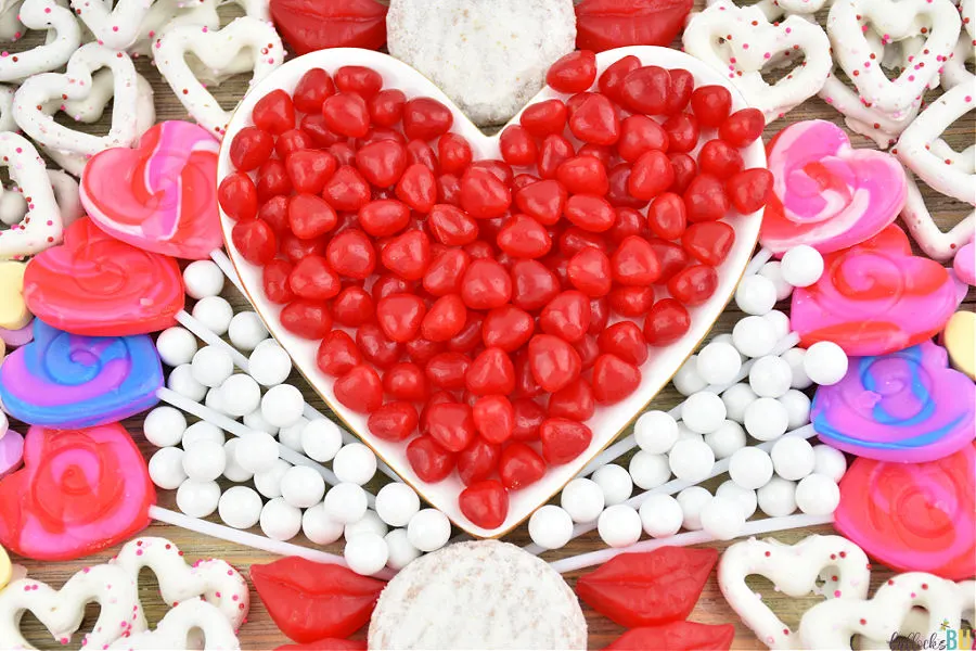 red hots candy in heart-shaped dish on candy charcuterie board