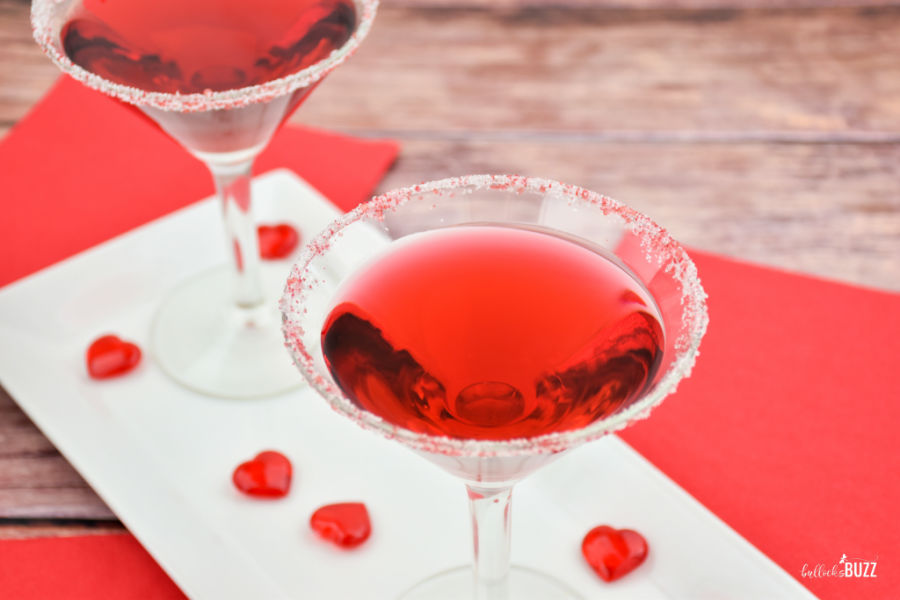 Red and white sanding sugar adds even more color to this pretty red cocktail for Valentine's Day!