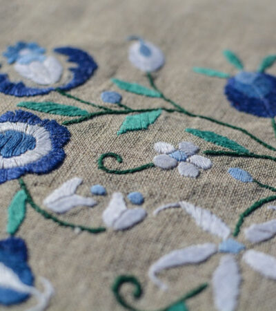blue floral embroidery design on grey fabric