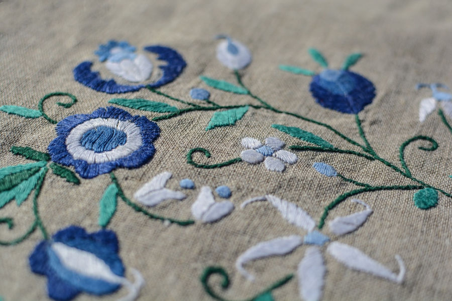 blue floral Embroidery Design on grey fabric