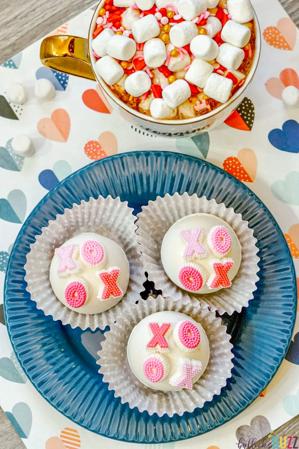 Close up of hot cocoa bombs decorated with XOXO candies.