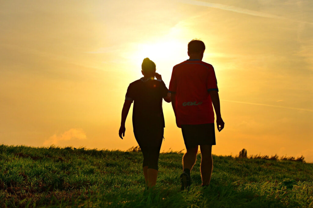 Spending quality time together like this couple walking through a field is a simple relationship goals