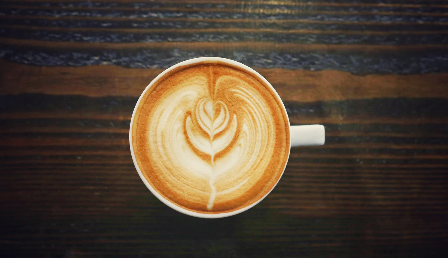 overhead view of latte in a mug