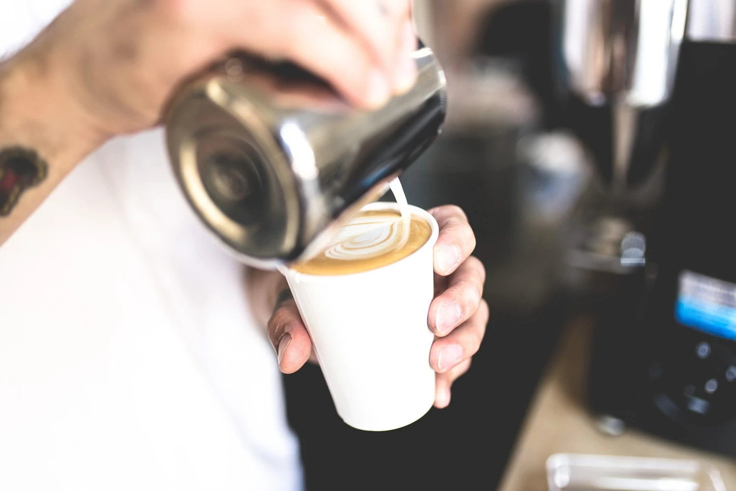 pouring milk to make latte art on top of the most popular espresso drinks