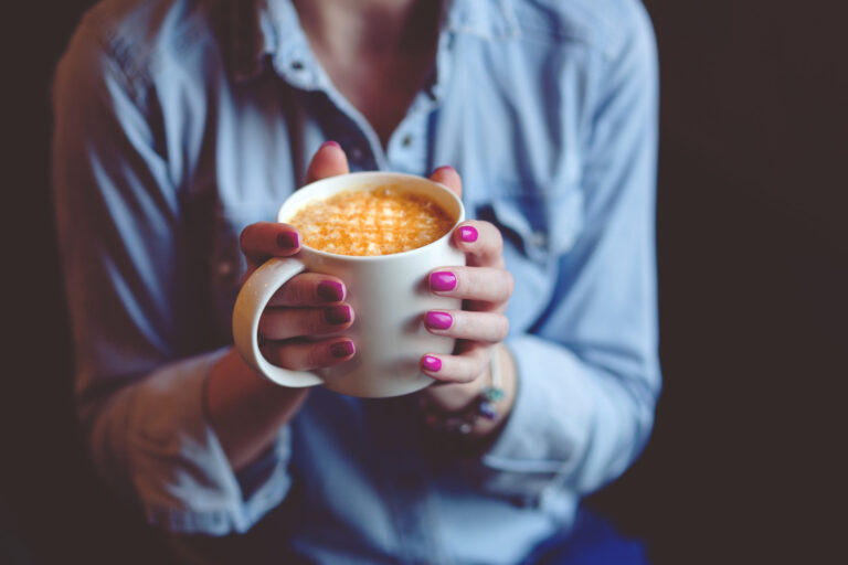 woman holding a mug of one of the most popular espresso drinks called lattelatte