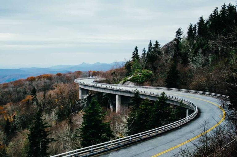 road winding through mountains is perfect for these traveling tips