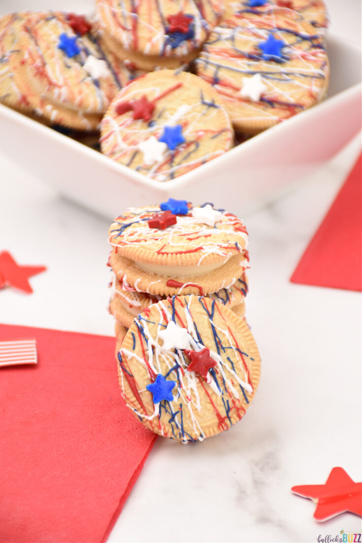 Patriotic Oreos are a fun and festive Fourth of July dessert with red, white and blue chocolate drizzles and star-shaped sprinkles. Best of all, they are very easy-to-make! #4thofJuly #snacks #July4th #easyrecipe