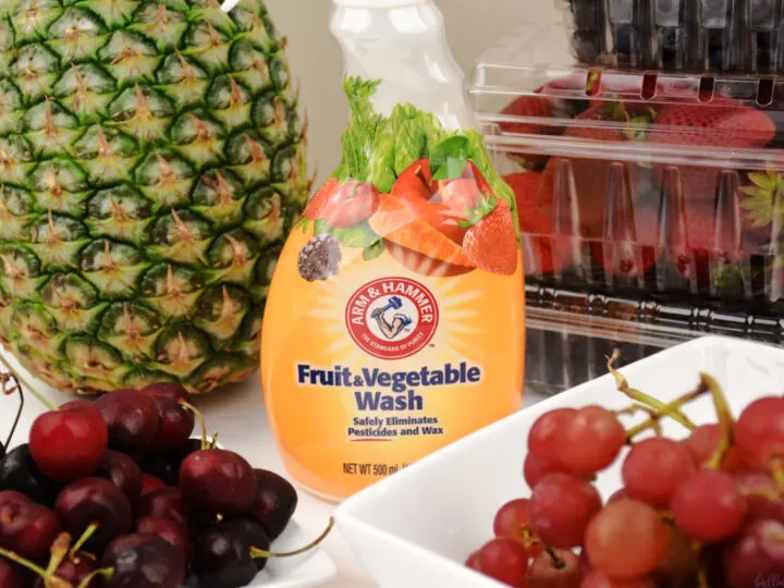 Arm & Hammer Fruit and Vegetable Wash bottle in front of fruit