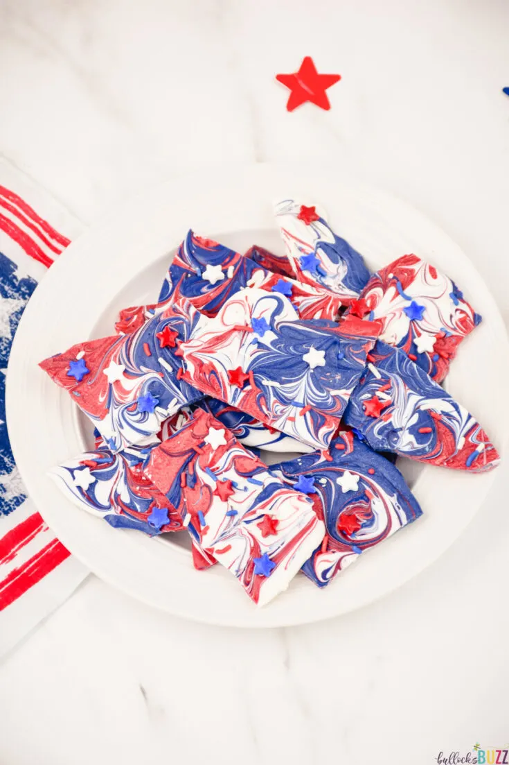 This easy homemade Patriotic candy bark makes a great red, white, and blue themed dessert. It's no-bake, so it comes together quickly. It has everything you could want in a 4th of July dessert: sweetness, pretty color, and pride! #4thofJuly #candybark #candy #recipe #candyrecipe