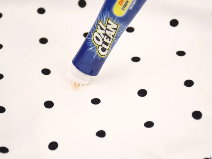 OxiClean pen cleaning off chocolate stain from white shirt