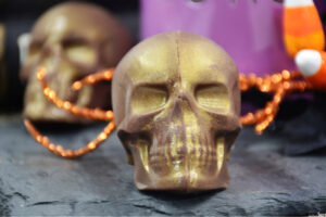 close up of gold skull hot cocoa bombs for Halloween