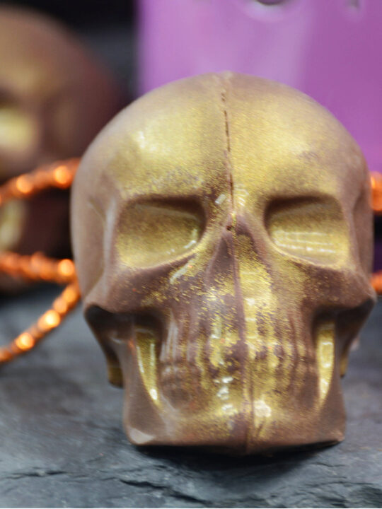 close up of gold skull hot cocoa bombs for Halloween