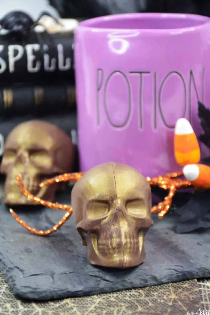 two gold Skull-Shaped Halloween Hot Chocolate Bombs