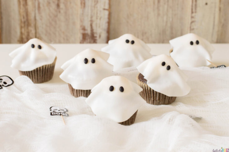Halloween ghost cupcakes on table