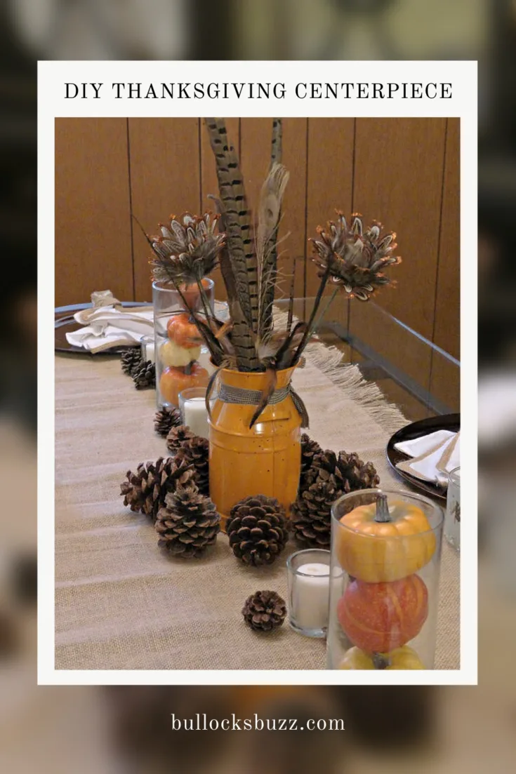 pretty yet simple DIY Thanksgiving centerpiece with milk can filled with autumn flowers surrounded by pinecones