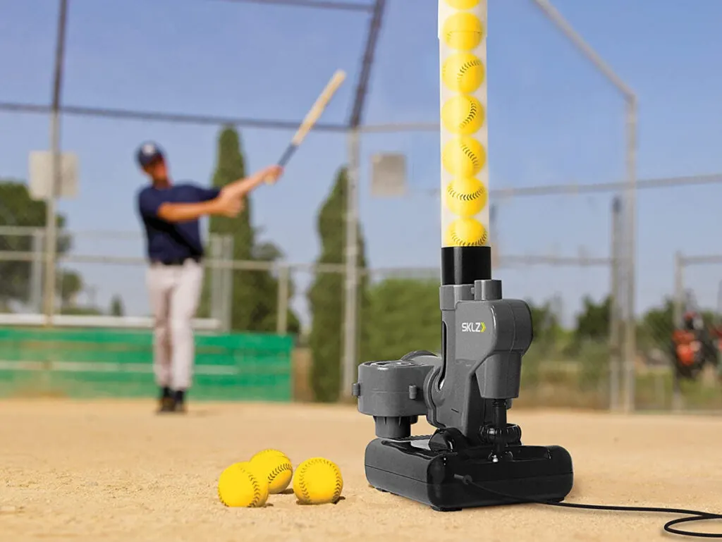 man practicing hitting with the SKLZ Lightning Bolt Baseball Pitching Machine