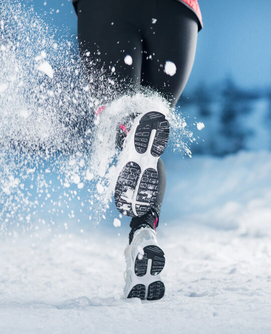 As part of learning to maintain a healthy lifestyle this winter, a woman is running in the snow
