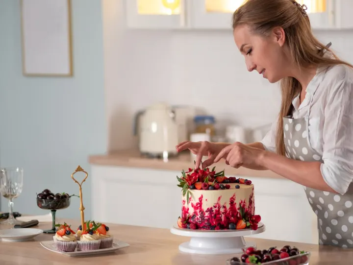 woman decorating a cake is another of the fun winter DIY projects