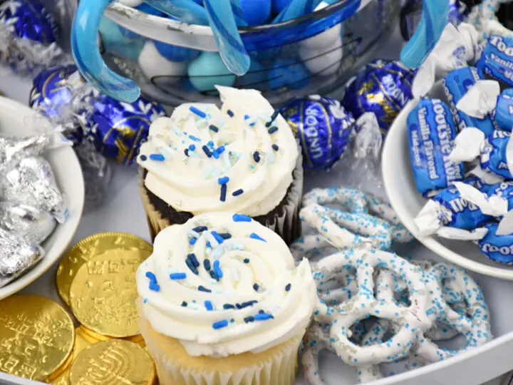 close up of cupcakes, pretzels and gelt on candy board