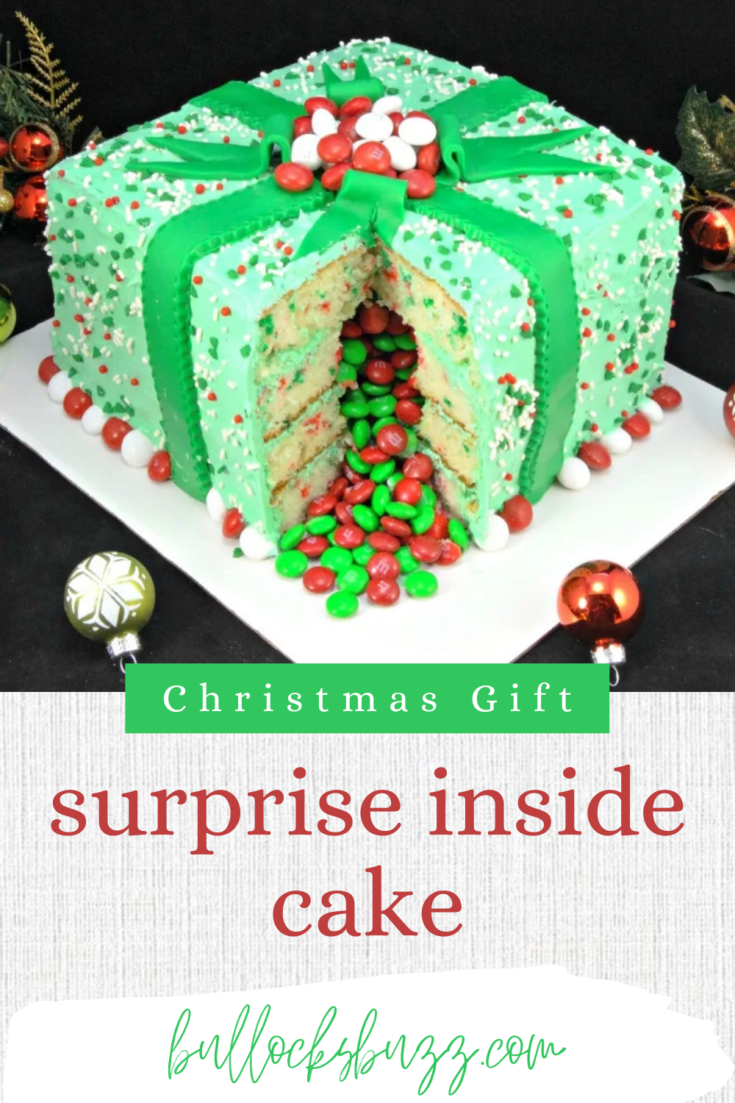 Shaped like a Christmas gift box, this surprise-inside Holiday Present Piñata Cake looks great, tastes amazing, and has a sweet candy surprise inside! #Christmas #Christmasrecipes #Christmascake #surpriseinsidecake #pinatacake #giftboxcake