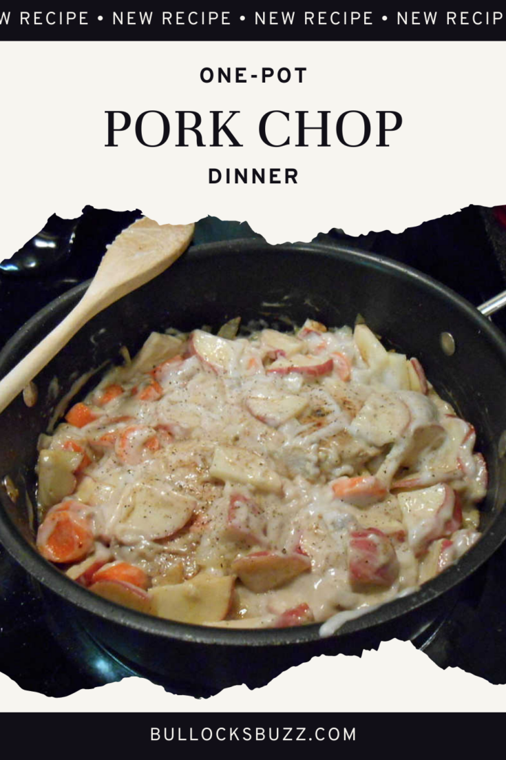 pork chops, potatoes and carrots in a rich cream of mushroom soup gravy simmering in a pan on the stove in this pork chop dinner recipe.